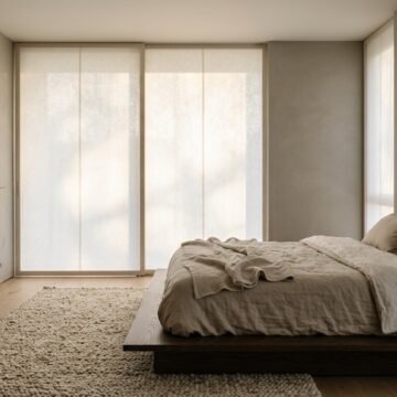 Calm Japandi bedroom with a low oak bed facing a large window in soft morning light
