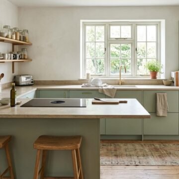 Bright kitchen with a long countertop, an island and a clear path between the sink, stove and fridge